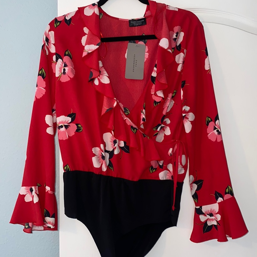 Beautiful floral body suit blouse with ruffle bell sleeve with tags! Brand new
